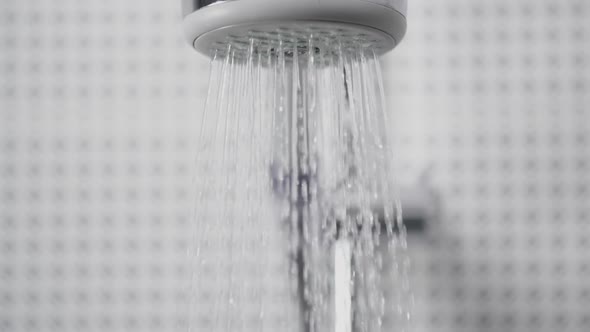 Turning On and Off the Shower Head in Bathroom Water Flowing, Falling Drops in Slow Motion