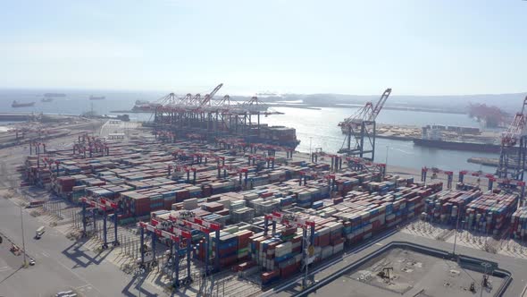 Cargo containers in busy port, aerial. Drone shot. 