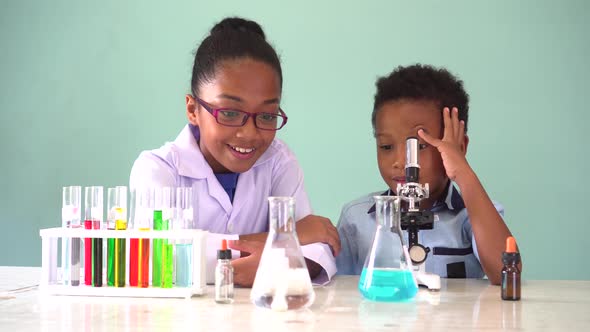 Two African American Mixed Kids Testing Chemistry Lab Experiment