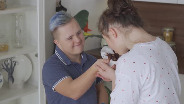 Young Couple with Down Syndrome In Love at Kitchen