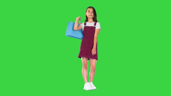 Pretty Asian Girl with Colorful Shopping Bags on a Green Screen Chroma Key