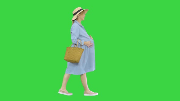 Attractive Pregnant Woman Smiling and Walking on a Green Screen, Chroma Key