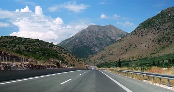 Driving car on highway with view on hills.