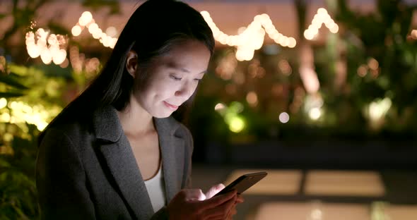 Business woman use of cellphone city city at night