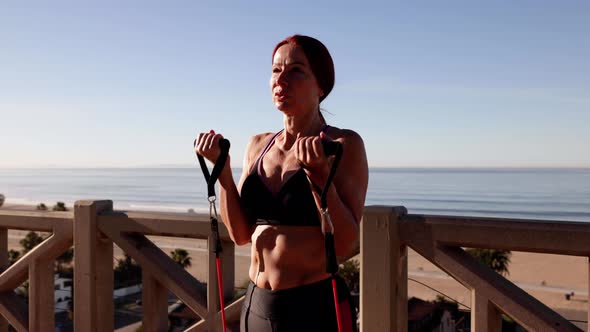 Mature Woman Exercising At The  Beach