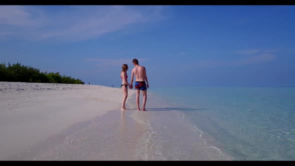 Teenage lovers happy together on perfect tourist beach adventure by blue sea and bright sand backgro