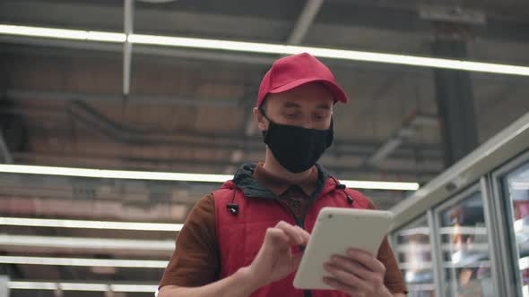 Merchandizer Using Tablet In Hypermarket