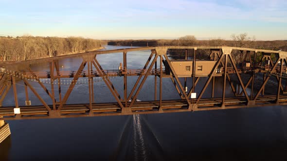 Seen from above, a boat passes under the old Hastings Rail Bridge in Minnesota.