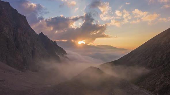 Mountains and Moving Clouds at Sunset. Aerial Hyper Lapse