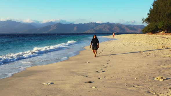 One woman suntans on tranquil shore beach trip by blue water and clean sandy background of the Maldi