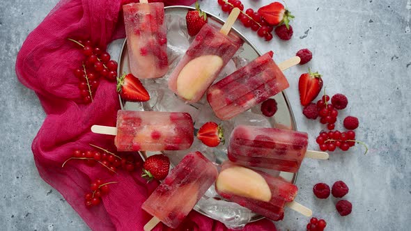 Strawberry Raspberry Apple and Red Currant Ice Cream Popsicles in Metal Tray with Ice Cubes