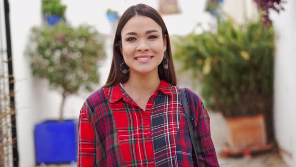 Cheerful Ethnic Woman in Checkered Shirt