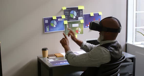 Businessman using virtual reality headset on desk 4k
