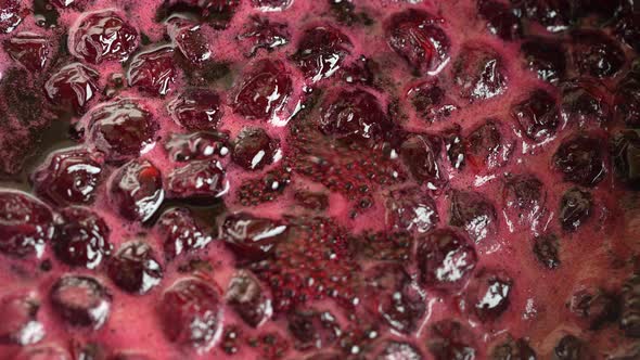 Preparation of freshly picked red cherries with sugar to make cherry jam