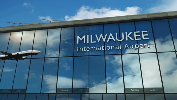 Airplane landing at Milwaukee Wisconsin, USA airport mirrored in terminal