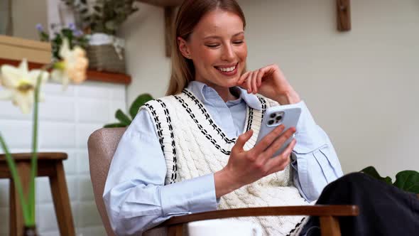 Laughing blonde woman typing by phone