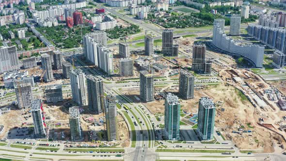 Aerial Top View Construction Site with Yellow Tower Cranes Working on Building Site in Big City