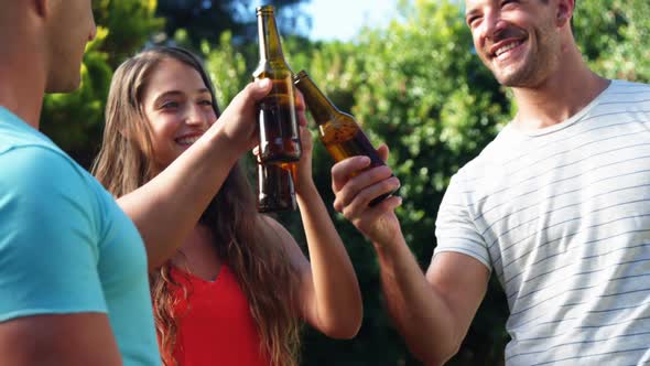 Group of friends toasting beer bottles