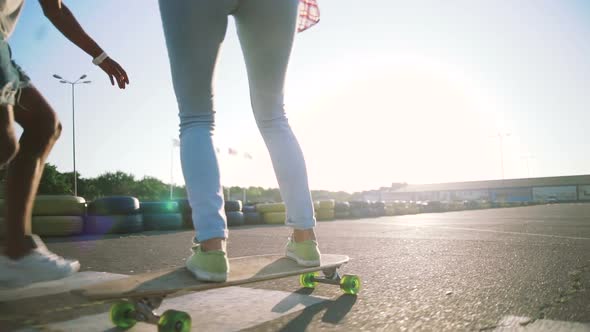 Young Attractive Mixed Race Couple Riding Skateboards and Having Fun Slow Motion