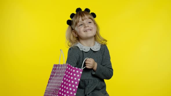 Child Girl with Shopping Bags Showing Black Friday Inscription, Satisfied with Low Prices Discounts