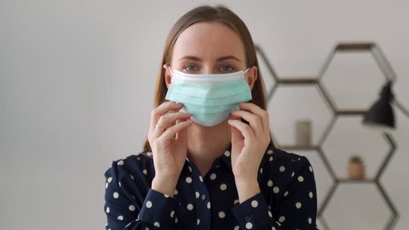 Young Woman Putting on a Mask on Face