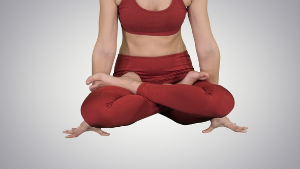 Sporty attractive woman practicing yoga standing in Scale