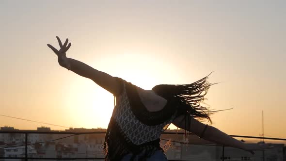 Dancing Female. silhouette happy mixed race woman dancing performance with long dreadlocks in shorts