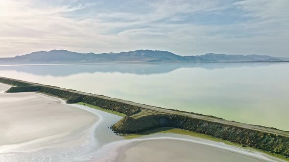 Aerial - Amazing Road and Mountains Reflection at the Great Salt Lake in Utah, Truck Right Shot.