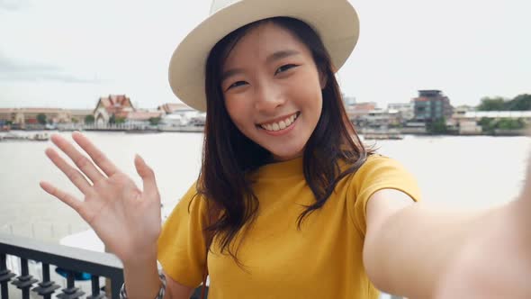 Beautiful Asian woman taking selfies on a smartphone.