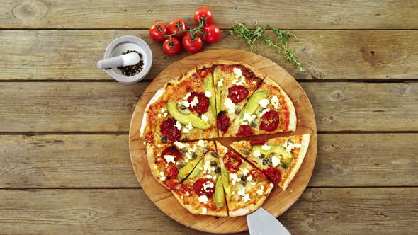 Delicious pizza with ingredients on wooden table