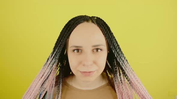 Young Woman with Senegalese Pigtails Looking at Camera