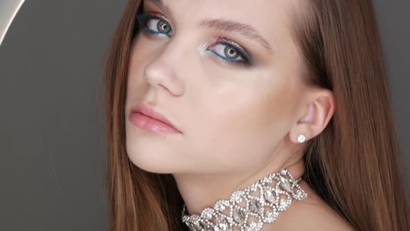 Portrait of Beautiful Young Girl Model in Stylish Evening Make Up Smoky Eyes Posing