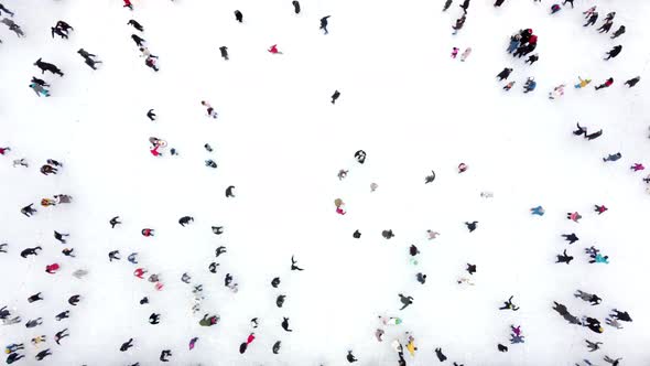 Aerial Drone View Over Many People Skating on an Openair Ice Rink in Winter