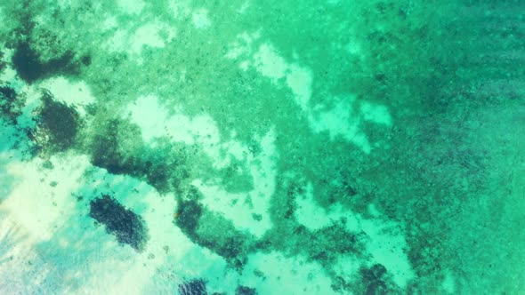 Aerial drone view abstract of tropical tourist beach adventure by transparent sea with clean sandy b