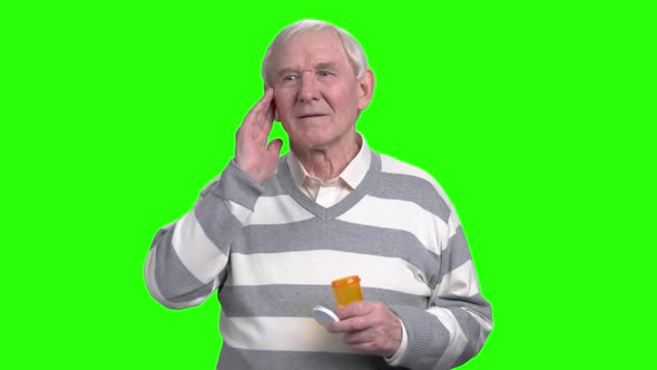 Old Man with Headache Holding Painkillers