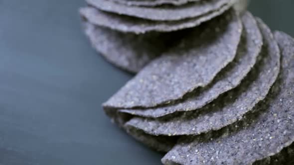 Blue corn taco shells on a gray background.