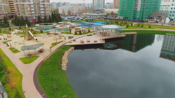 Lake with Pier and Playground Near Residential District