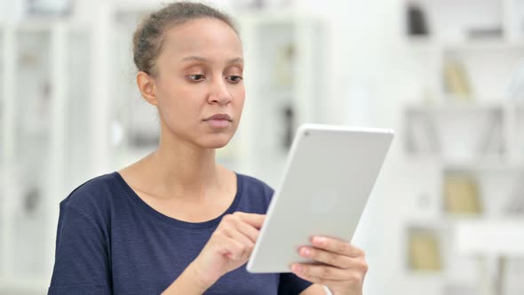 Portrait of Excited African Woman Having Success on Tablet 