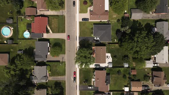 Aerial birds eye flight over suburban Neighborhood of Welland in Canada. Driving cars on highway and