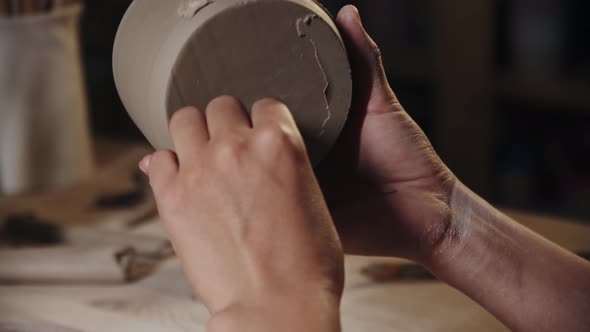 Woman Potter Chipping Away the Wet Excess of the Clay From the Bottom of a Cup