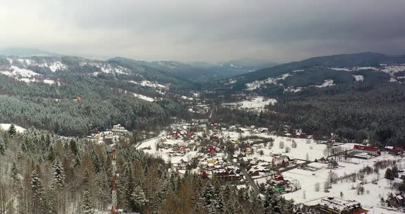 Forest Covered with Snow Aerial View. Aerial View of Village in Mountains