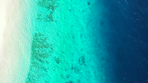 Natural flying abstract view of a sandy white paradise beach and aqua turquoise water background in 
