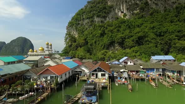 Koh Phanyee Traditional Floating Muslim Fishing Village surrounded by Limestone Cliffs at Phang Nga