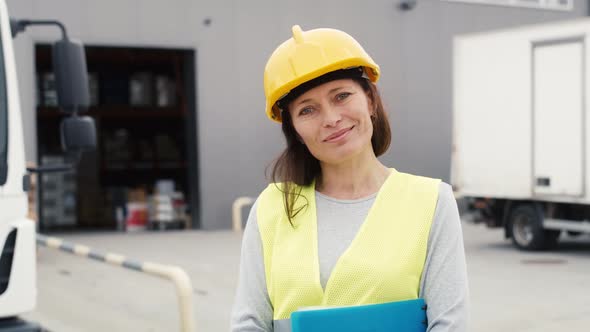 Portrait of caucasian woman in front of warehouse. Shot with RED helium camera in 8K.