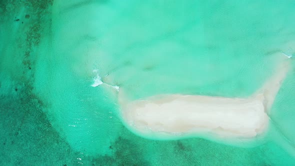 Copy space with white sandy dune in the middle of turquoise lagoon flowing over sand by tide rising