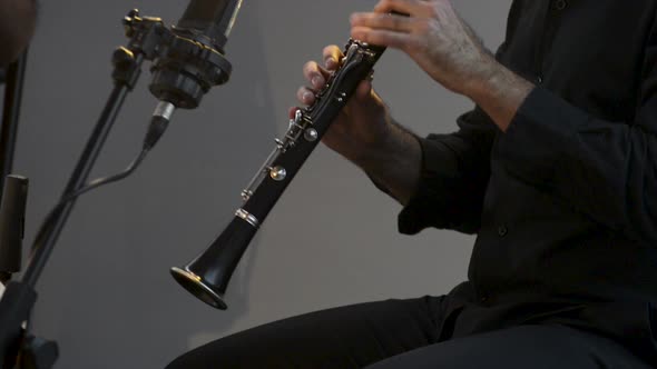 Clarinetist at a concert, theater scene, clarinet, flat plane closeup