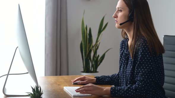 Woman is Using Headset for Online Communication