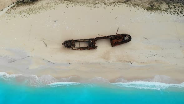 A Drone Flies Back Over Shipwreck Beach of Zakynthos Island on a Sunny Day