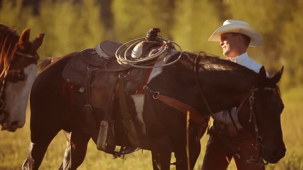 Group of cowboys saddle up and prepare for ride