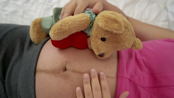 Happy Pregnant Woman Sleeping on Bed in Bedroom